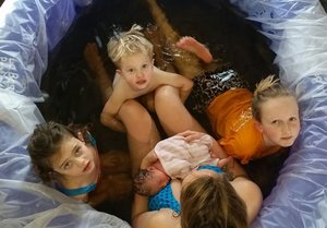 Beautiful home-birth surrounded by siblings